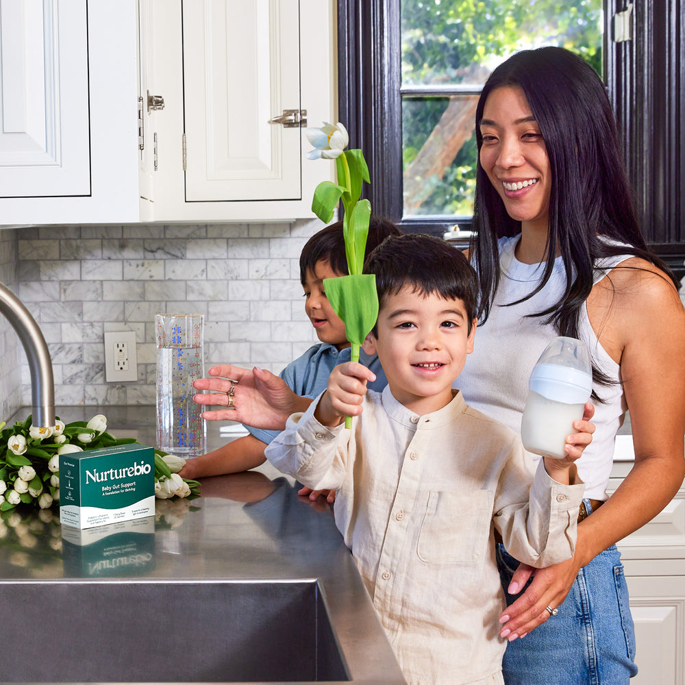 A mom in her kitchen with her two children and a NurtureBio box