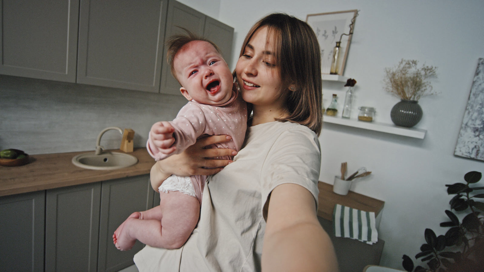 Mother holding crying baby