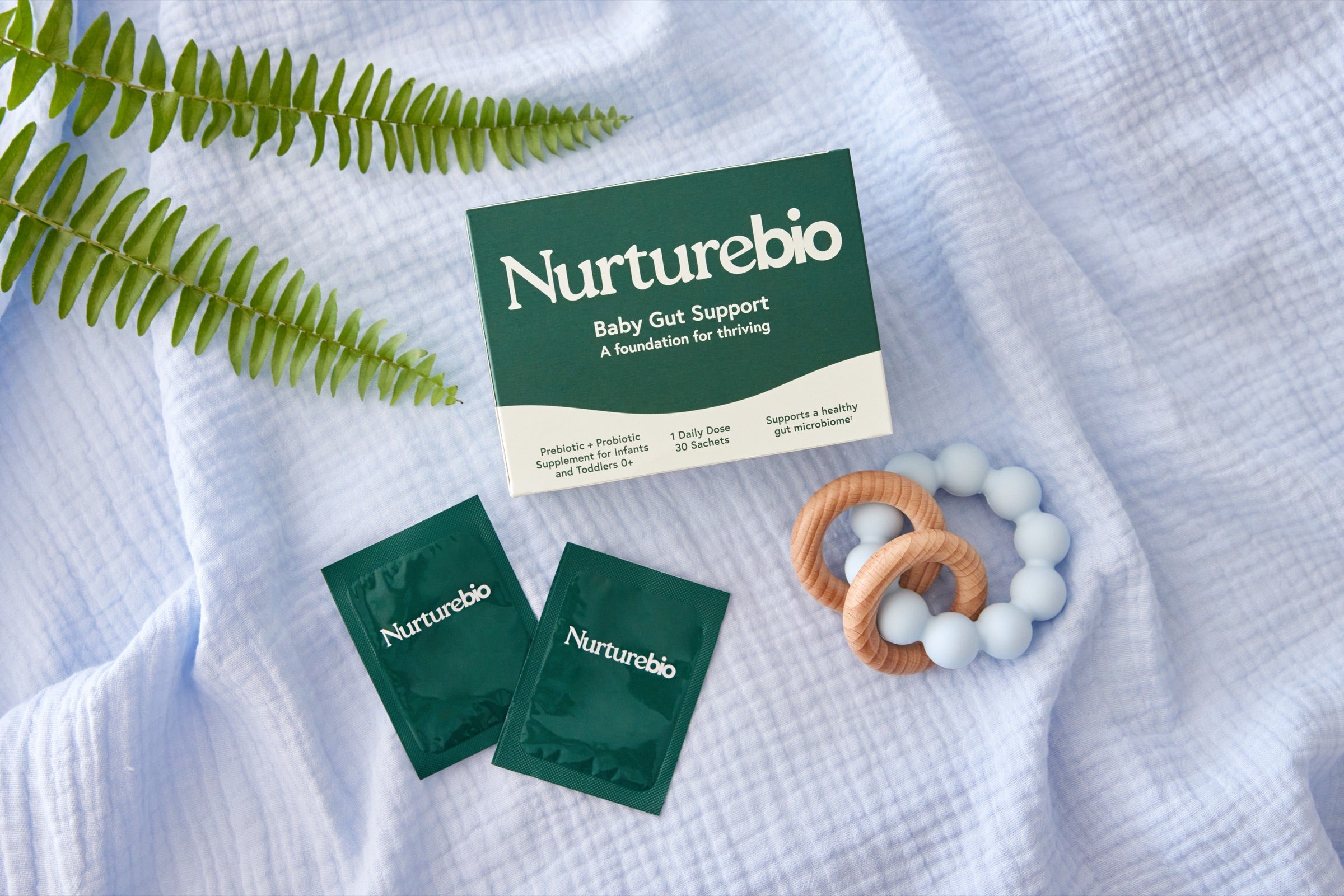 A family in a bright kitchen with the NurtureBio Baby Gut Support box